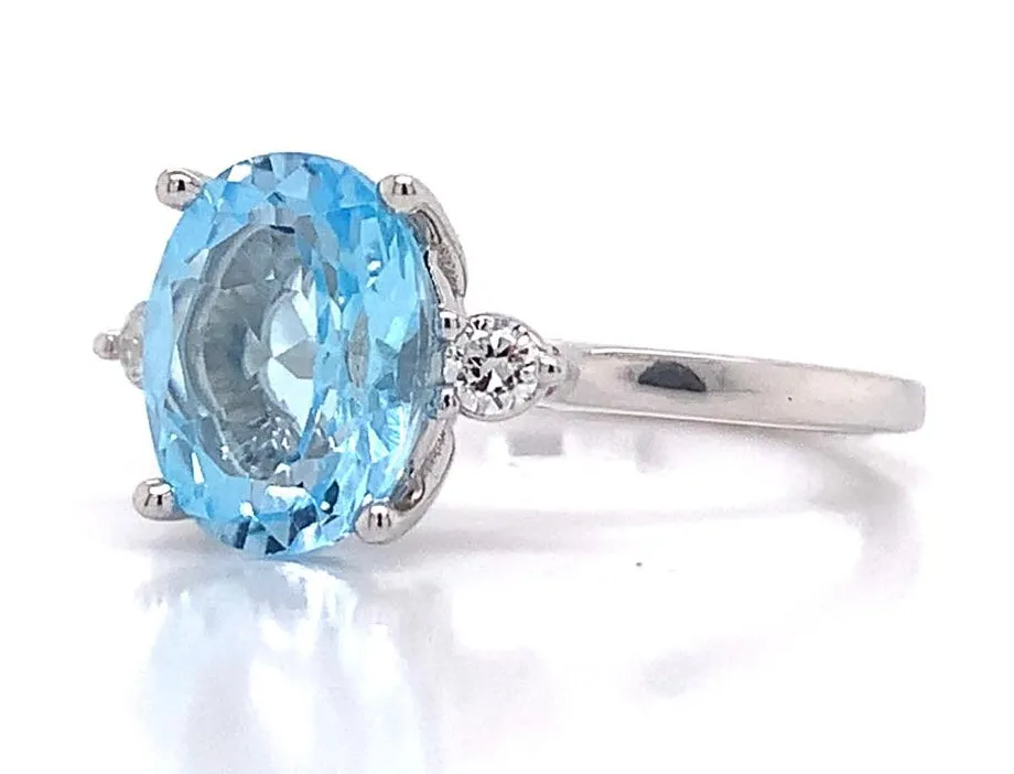 9ct White Gold 2.50ct Earth Grown Oval Sky Blue Topaz And 0.08ct Diamond Ring